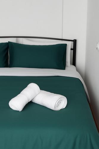 a stack of towels laying on a bed at 3 Mountains Luxury House in Aridaia