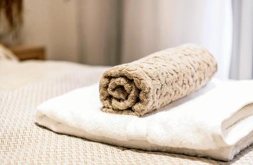 a towel sitting on top of a bed at Premium Center Apartment in Durrës