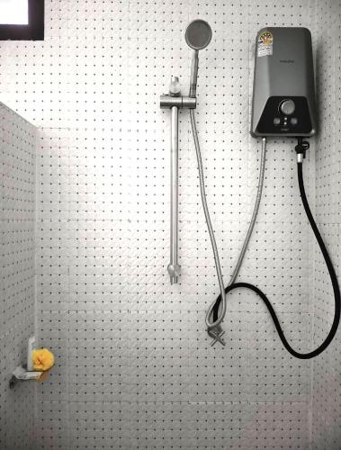 a bathroom with a blow dryer on a wall at Naranta House in Ko Raeng