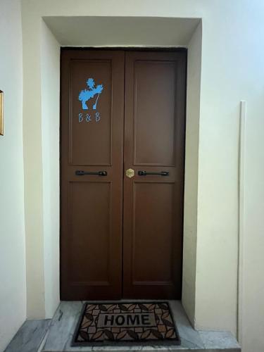 a brown door with a home sign on it at Il Tronchetto in Monte Libretti