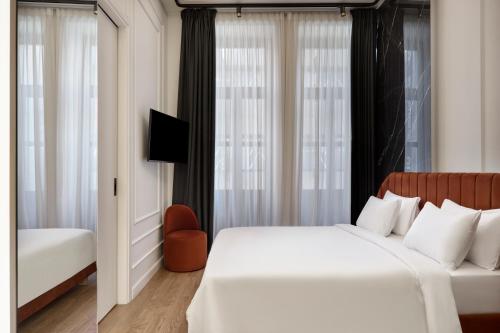 a hotel room with a bed and a window at Athens Icon Collection in Athens