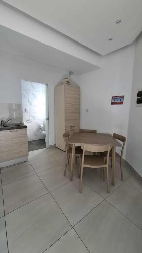 a dining room with a wooden table and chairs at Cosy studio close to Qawra Beach in St. Paul's Bay