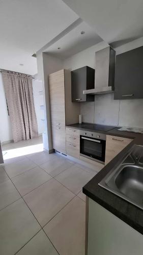 a kitchen with a sink and a counter top at Cosy studio close to Qawra Beach in St. Paul's Bay