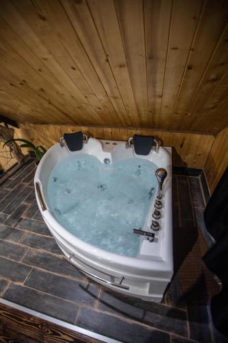 a bath tub filled with water in a wooden ceiling at AAA Byurakan Rest House in Ashtarak