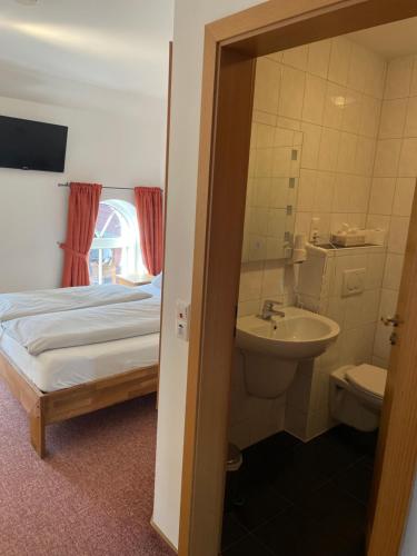 a bedroom with a bed and a sink and a toilet at Bleckmanns Hof in Werne an der Lippe