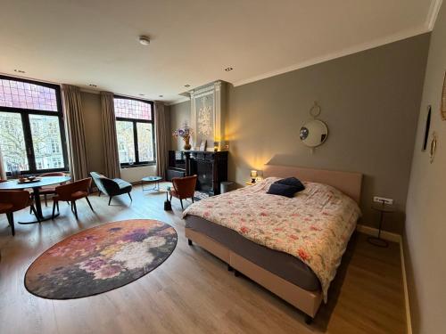 a bedroom with a bed and a table and chairs at Maastricht Suites - City Studio A in Maastricht