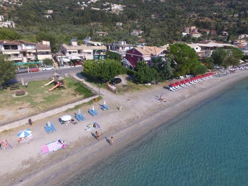 an aerial view of a beach with chairs and umbrellas at Sundy's Studios in Nydri