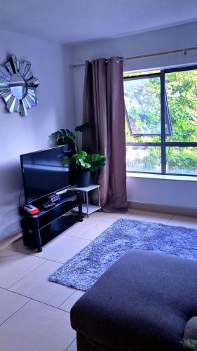 a living room with a couch and a window at 2bed city centre apartment in Limerick