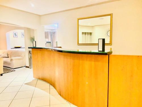 a bar in a hotel room with a mirror at Siena Sun Celebration House Party friendly noise tolerant in Midrand