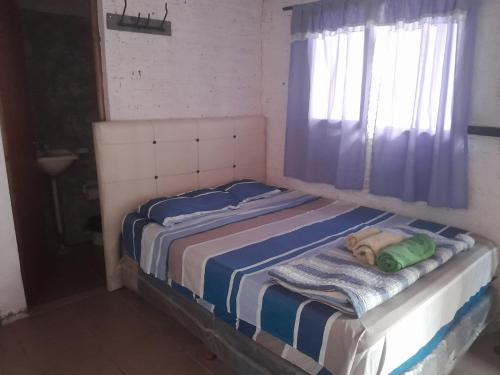 Ένα ή περισσότερα κρεβάτια σε δωμάτιο στο El Rincón del Capibara Alojamientos