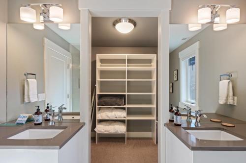 a bathroom with two sinks and a walk in closet at Hillside Haven in Bend