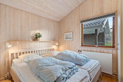 un letto in una stanza con una finestra di BL1144-Blokhus-Sixtusvej-27 a Hune