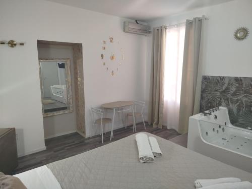 a white bathroom with a sink and a bath tub at Idromassaggio Room in Catania
