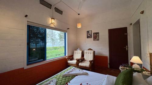 Ένα ή περισσότερα κρεβάτια σε δωμάτιο στο Kuzhupilly Beach House