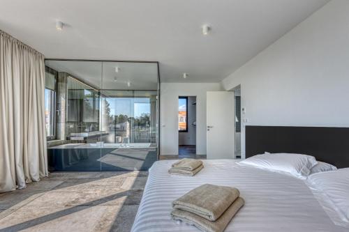 En eller flere senge i et værelse på Villa A by Tourist Adria Group