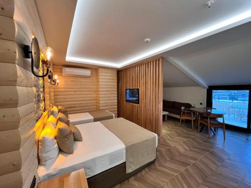 a hotel room with a bed and a dining room at Gumus Palace Hotel in Istanbul
