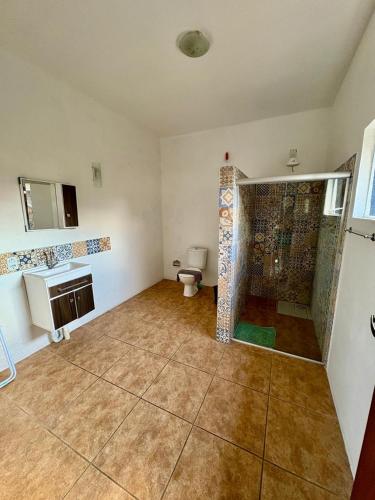 a bathroom with a shower and a toilet in it at Residencial Solar del Nieto in Garopaba