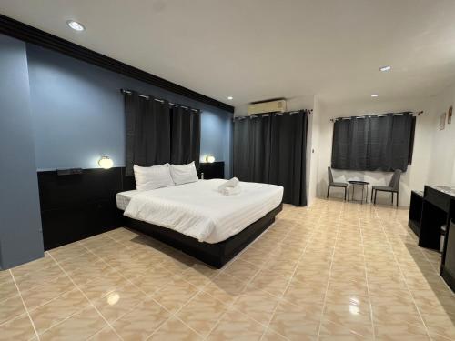 a bedroom with a bed and a table and chairs at Chapter 26 in Patong Beach