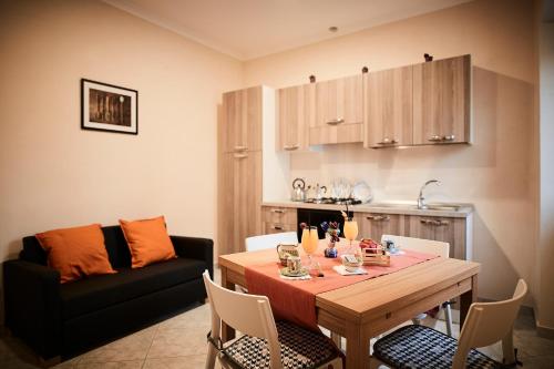 a kitchen and dining room with a table and a couch at Casa Vacanze La Trinità in Ravello
