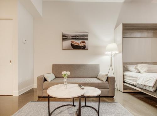 a living room with a couch and a table at Confort et style en plein Montréal in Montréal