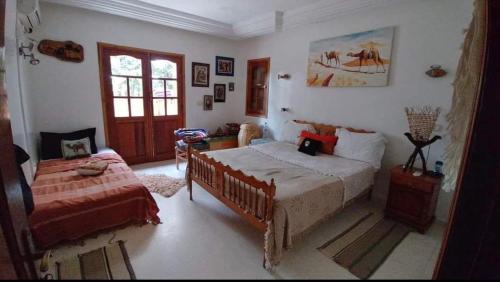 a bedroom with a bed and a chair and a window at Darsawani in Triffa