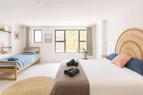 a bedroom with two beds and a window at Wildlife and Ocean Cottage in Scarborough