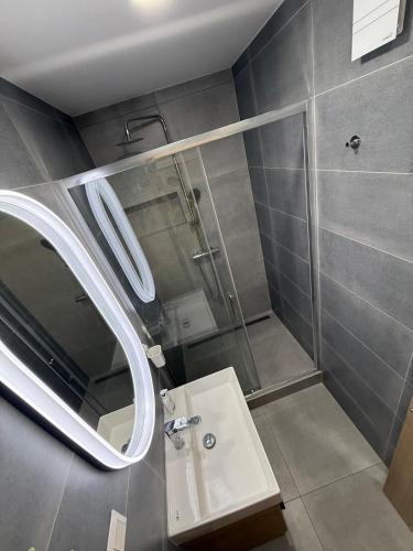 a bathroom with a sink and a mirror at Thurzova Residence 5 in Martin