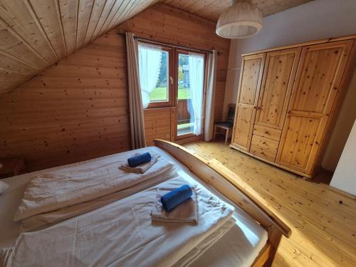 a bedroom with a bed in a wooden house at Triberga Verwall in Sankt Gallenkirch