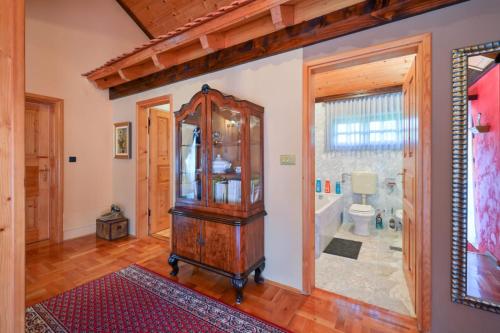 a bathroom with a grandfather clock and a toilet at Villa Requiem in Bednja