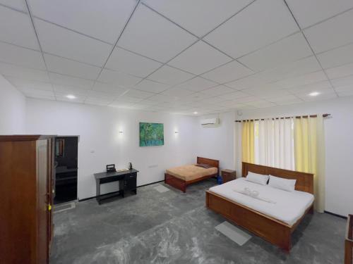 En eller flere senge i et værelse på Amore Beach Resort