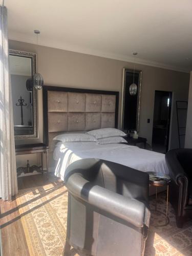 サマーセット・ウェストにあるThe Nestの大きなベッドと鏡のある寝室