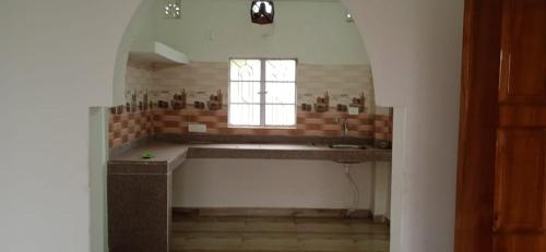 a bathroom with a large tub and a window at Cinchonna Farmstay in Darjeeling