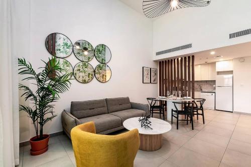 a living room with a couch and a table at Modern 1BR Apartment Lamtara 3 in MJL in Dubai