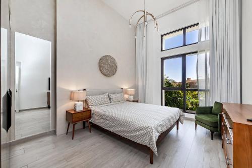 a bedroom with a bed and a desk and a window at Modern 1BR Apartment Lamtara 3 in MJL in Dubai
