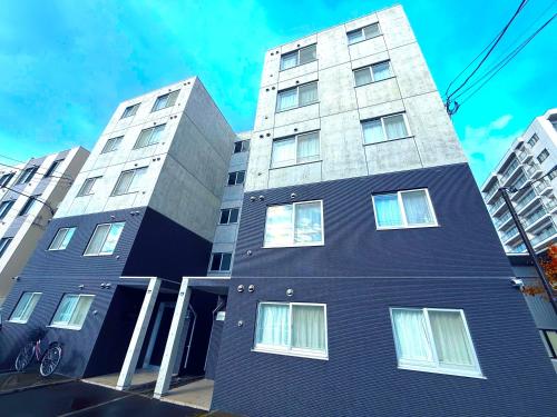 a tall building with windows on the side of it at Excel 平岸B -FIX HOME- in Sapporo