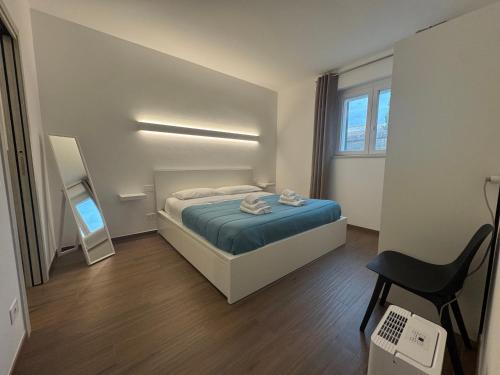a small bedroom with a bed and a chair at Appartamento alle Terme in Rapolano Terme
