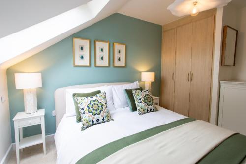 a bedroom with a large white bed with pillows at Crucible House - 2-Bed Apartment in Stratford-upon-Avon