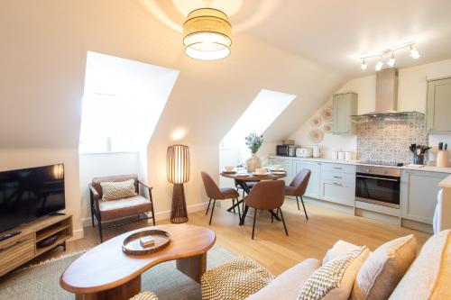 a living room with a couch and a table at Crucible House - 2-Bed Apartment in Stratford-upon-Avon
