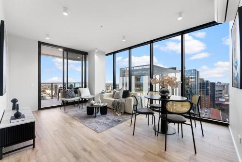a living room with a table and chairs at City sky view self service apartment free parking in Adelaide