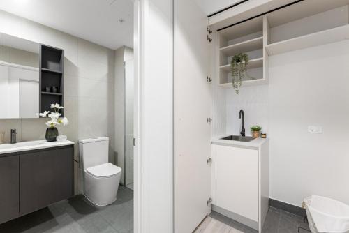 a bathroom with a toilet and a sink at City sky view self service apartment free parking in Adelaide