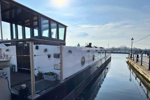 a boat is docked at a dock in the water at The Swan Flotel - Barton Marina in Burton upon Trent