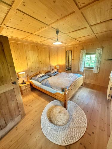 a bedroom with a bed in a wooden cabin at Ferienwohnung Eggerhof-Schaller in Innervillgraten