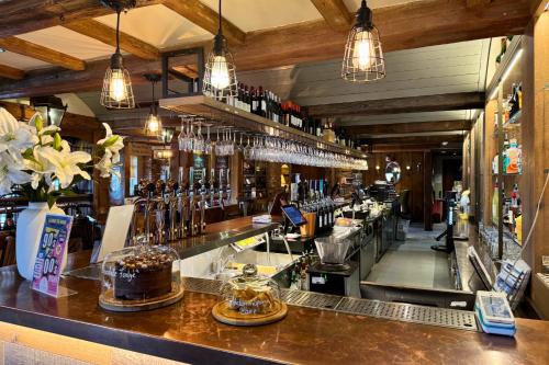 a bar with a lot of bottles of alcohol at The Swan Flotel - Barton Marina in Burton upon Trent