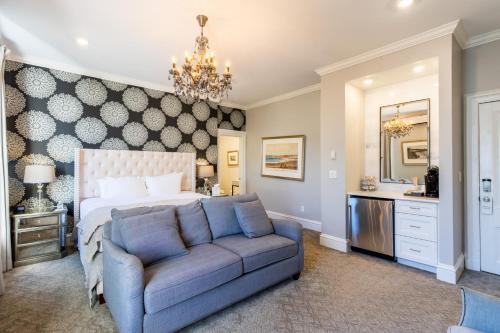 a bedroom with a bed and a blue couch at Serenity Inn Newport in Newport