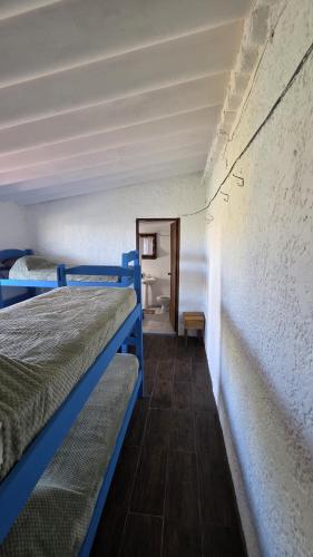 a room with two bunk beds in a room at La Farola del Cabo in Cabo Polonio