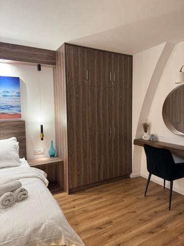 a bedroom with a bed and a desk at The Colony - By Lime Luxe in Haifa
