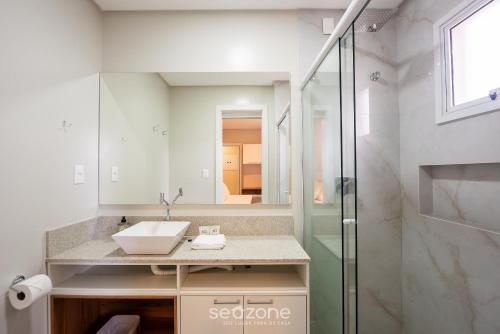 a bathroom with a sink and a shower at Apto c/ Churrasqueira a 500m da Praia TDF0302 in Itapema