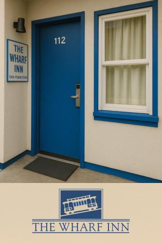 a blue door in a building with a window at The Wharf Inn in San Francisco