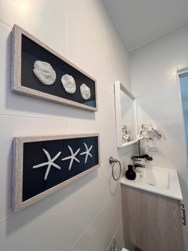 a bathroom with planets and a sink and a mirror at Boho Vibes Punta Cana in Punta Cana