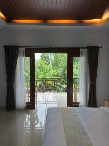 Ένα ή περισσότερα κρεβάτια σε δωμάτιο στο D'Kusuma House Sidemen